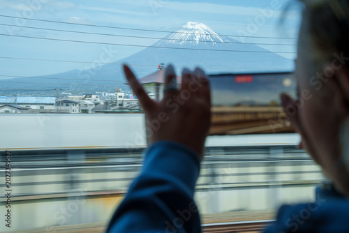 Φωτογραφία Woman (intentionally de-focused) uses a phone to take photos of Mt