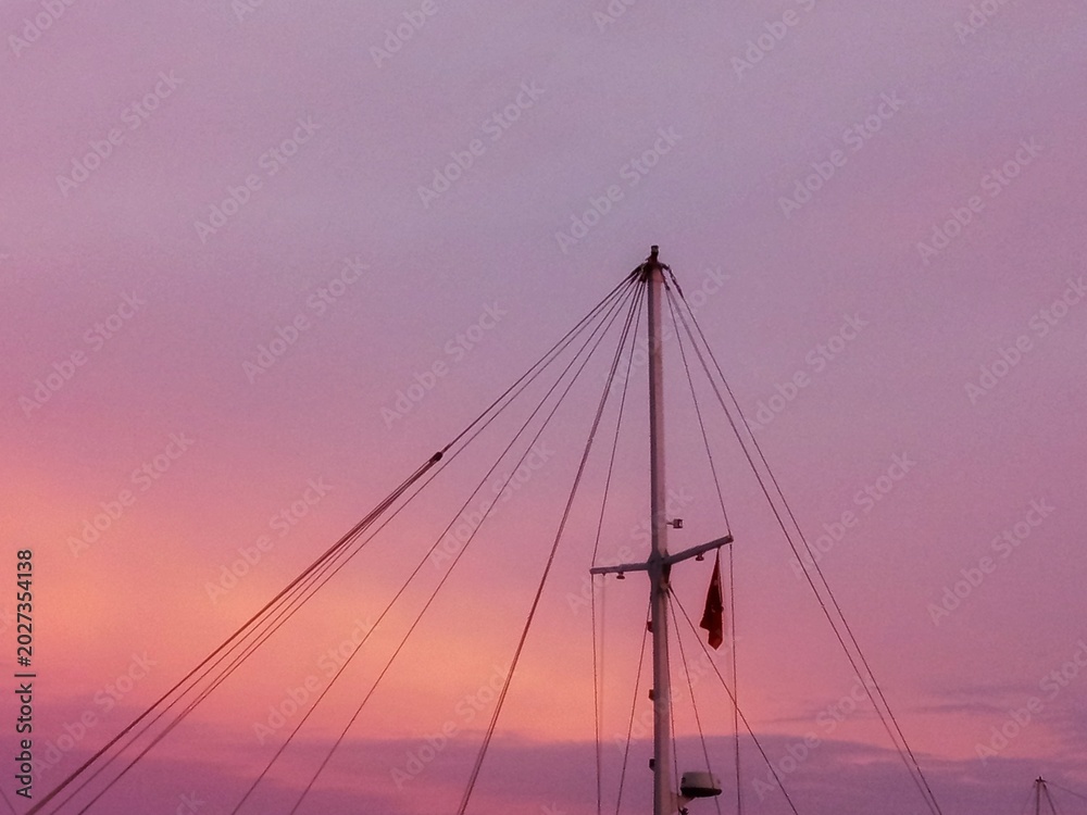 Fototapeta premium Sailboat Mast Against Colorful Sunset Sky