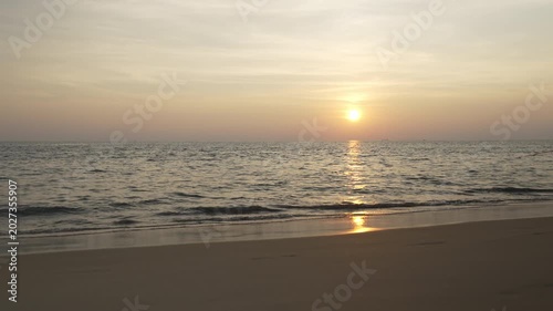 Serene Sunset Over Calm Ocean Gentle Waves Lapping at Sandy Beach Creating Peaceful Atmosphere