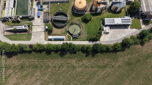 Water Treatment Plant from Above: An aerial view showcases a sprawling water treatment facility, with large tanks and circular clarifiers at the heart of the industrial complex.