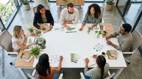 Diverse business team collaborating on sustainable ESG eco strategy in modern office meeting