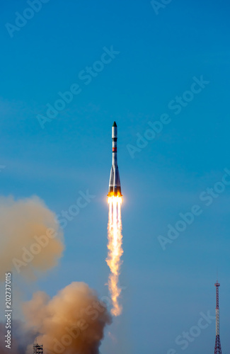 Take-off of a real launch vehicle from a spaceport. A rocket takes off into the sky against a background of clouds. Startup concept, power of science and technology.
