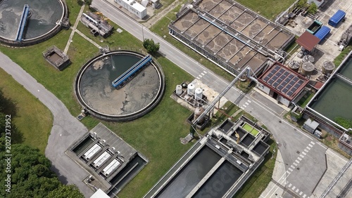 Water Treatment Plant Overview: An aerial view showcases the intricate infrastructure of a modern water treatment plant, highlighting the complex network of tanks, channels.