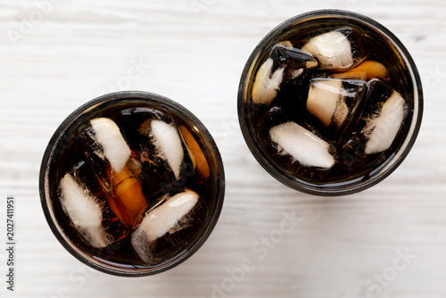 Refreshing Dark Cola with Ice Cubes in Glasses, top view.