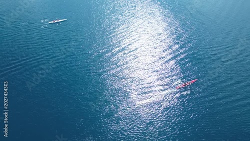 Aerial View of Rowing Race Competition in Turquoise Sea Near Coastal Hills. High quality 4k footage