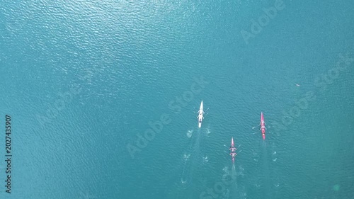 Top Down Aerial View of Rowing Boats Competing in a Race on Turquoise Sea. High quality 4k footage