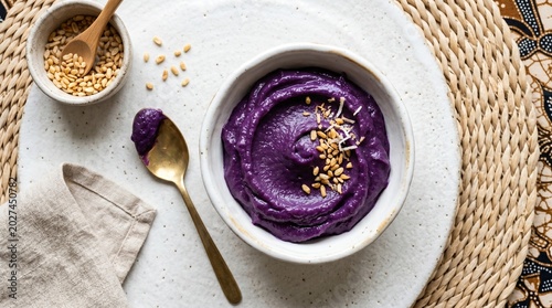 Flat Lay of Filipino Ube Halaya Purple Yam Dessert with Toasted Grains and Golden Spoon