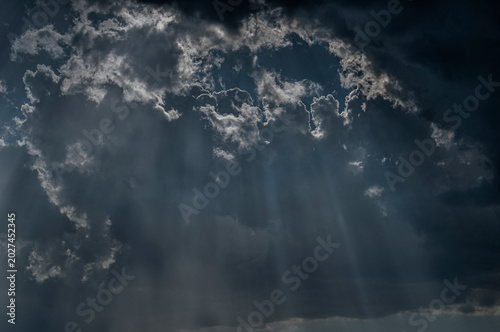 Slika na platnu The natural phenomenon of sunlight shining through clouds, often referred to as God rays or the Tyndall effect