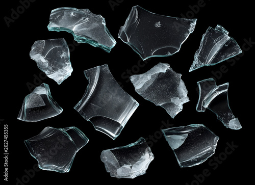 Scattered Broken Glass Shards and Transparent Fragments on Isolated Black Background