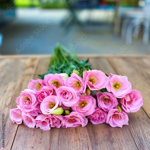 Bouquet of Pink Flowers on a Wooden Table in a Bright Indoor Space During Day...