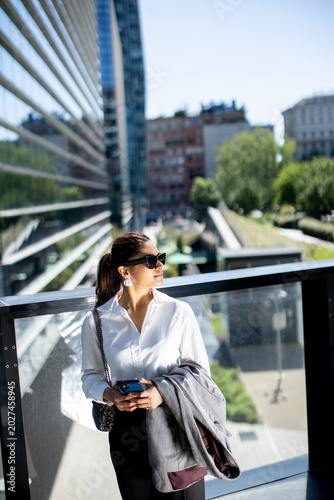 Woman stands outside in a c...