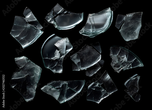 Set of Shattered Glass Shards and Fragments Isolated on Black Background