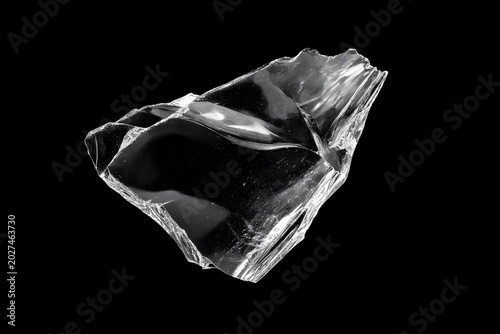 Large Jagged Shard of Transparent Glass Isolated on Black Background
