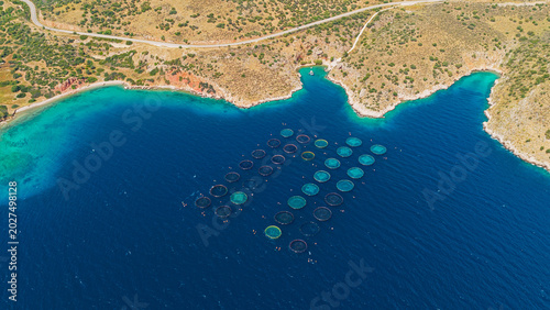 Bild auf Leinwand Fish farm with numerous circular cages floating in the vibrant blue mediterranea
