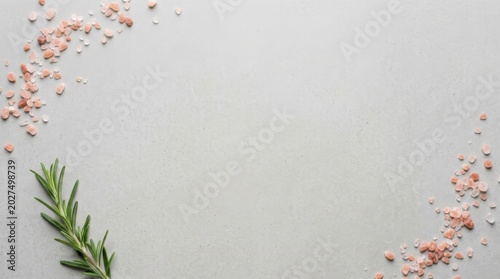 Pink Himalayan Salt and Fresh Rosemary on Light Stone Background