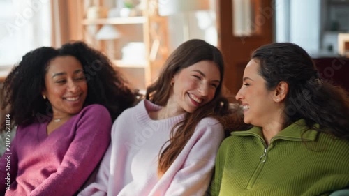 Smiling girls falling couch enjoying time together at domestic weekend closeup. 