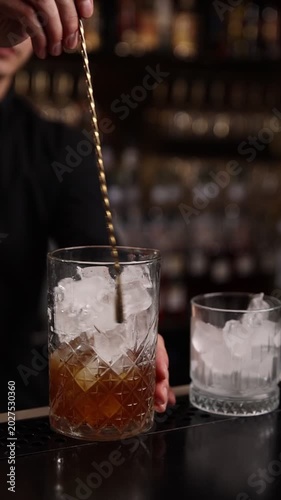 A skilled bartender expertly crafts a fresh cocktail behind a stylish bar counter
