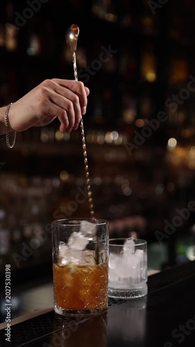 A skilled bartender expertly crafts a fresh cocktail behind a stylish bar counter