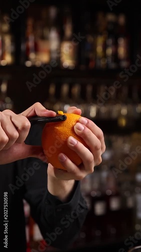A skilled bartender expertly crafts a fresh cocktail behind a stylish bar counter