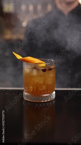 A skilled bartender expertly crafts a fresh cocktail behind a stylish bar counter
