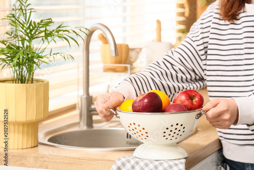 Woman taking colander with ...