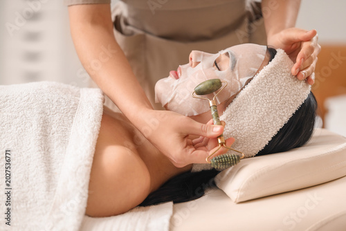 Cosmetologist with massage ...