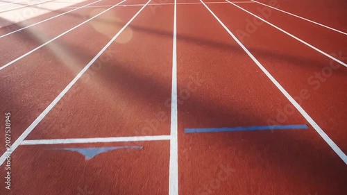 Red athletic track with white lines.