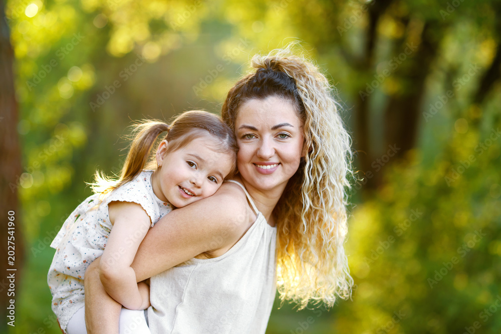 Fototapeta premium Mother with her cute little daughter in nature