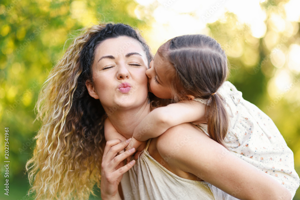 Fototapeta premium Mother with her cute little daughter in nature, closeup