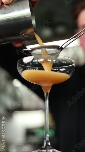 Bartender preparing a signature cocktail in a stylish moody bar. Cinematic atmosphere, premium nightlife vibe, ice, light reflections, and professional mixology.
