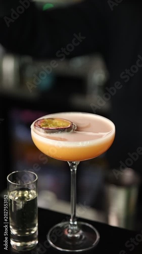 Bartender preparing a signature cocktail in a stylish moody bar. Cinematic atmosphere, premium nightlife vibe, ice, light reflections, and professional mixology.