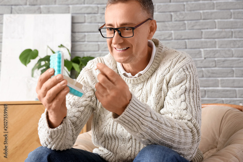 Middle-aged man with pillbo...