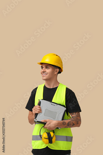 Young male engineer with la...