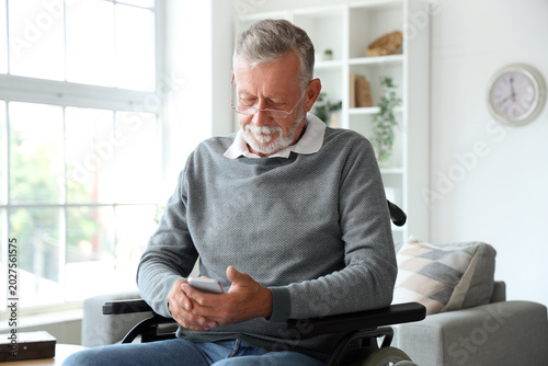 Senior man in wheelchair us...
