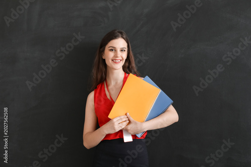 Female teacher with noteboo...