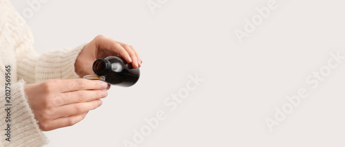 Woman pouring cough syrup f...