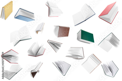 Foto Many flying books on white background