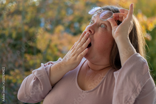 Photos middle-aged mature woman with bulging eyes, face close-up, goggle eyes in fright