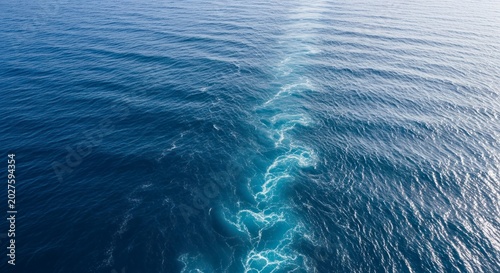 Vast Blue Ocean Divided by the Foaming White Wake of a Passing Ship.