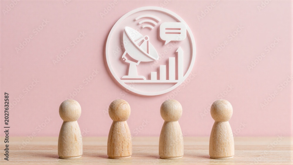 Fototapeta premium Wooden figures face a communication icon symbolizing teamwork and