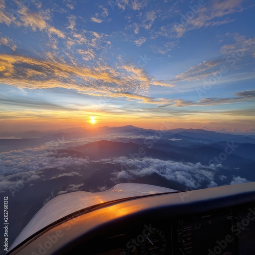 Sunset Over Mountain Range From Aircraft Cockpit with Vibrant Sky and Cloudscape