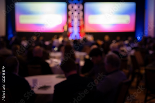 Canvastavla Blurred audience at corporate conference presentation event.