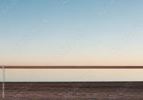 Minimalist horizon scene tranquil water and sky in natural tones