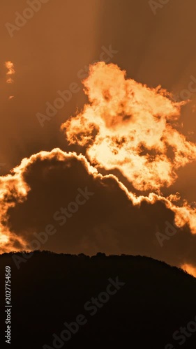 Wide angle time-lapse of scenic mountain range at sunrise, dramatic cloud formations and natural beauty.