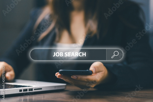 Businesswoman using smartphone and laptop for online job search with virtual search bar interface, remote recruitment, digital career application and modern employment technology concept.