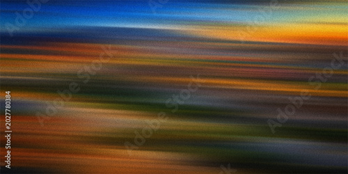 Abstract motion blur background with vibrant colorful streaks of orange blue and yellow light creating dynamic energy movement.