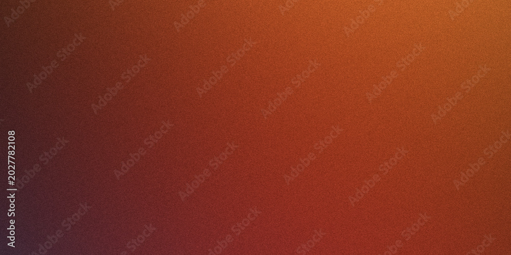 Fototapeta premium Abstract texture background with vibrant orange and red gradient, speckled surface resembling fine grain or dust.