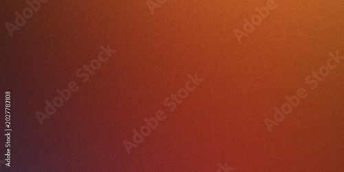 Abstract texture background with vibrant orange and red gradient, speckled surface resembling fine grain or dust.
