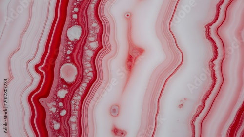 Swirling fluid red and white agate stone texture with natural wavy lines