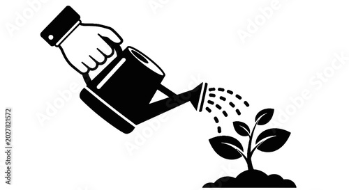Foto Hand watering a small green plant.
